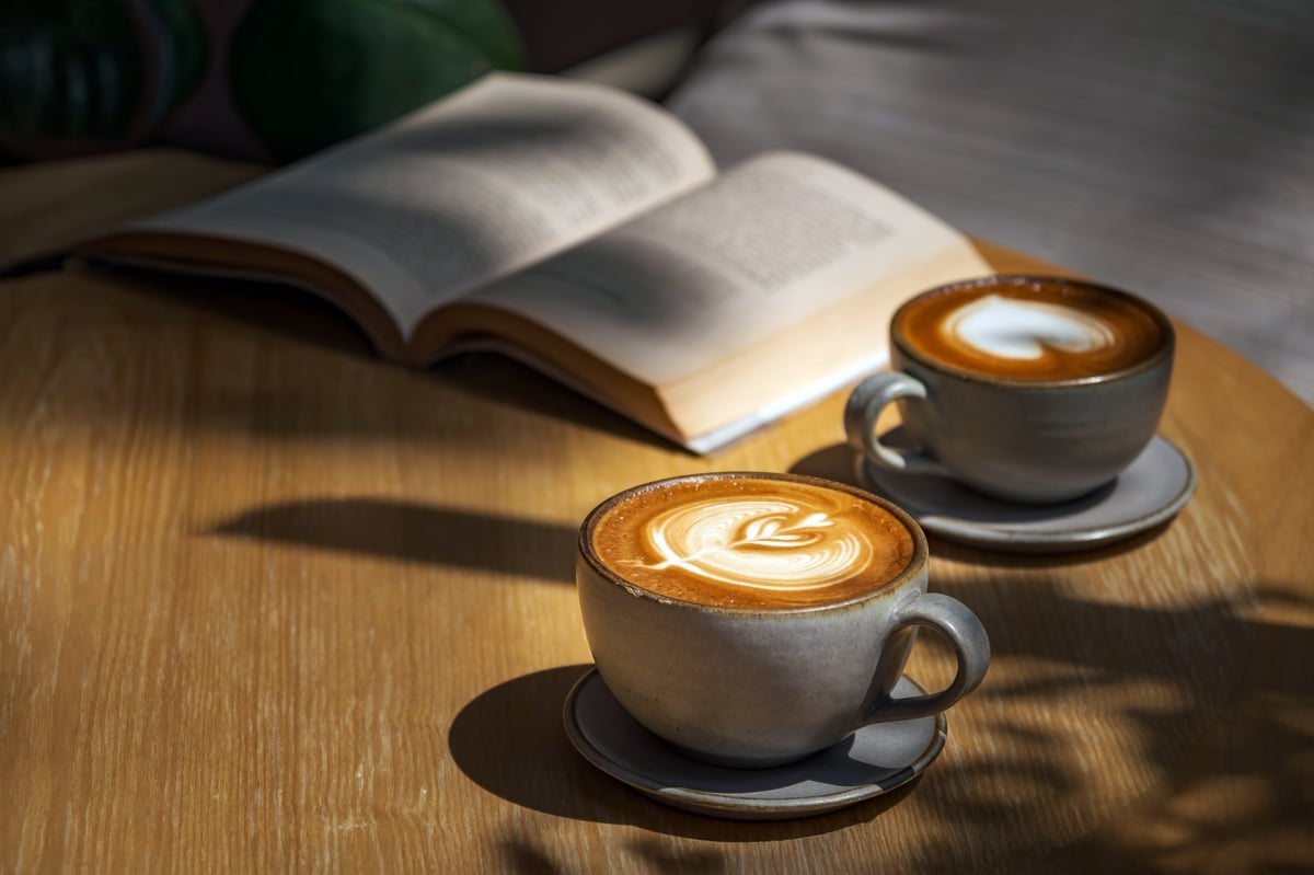 Latte resting on a wooden table with warm natural light